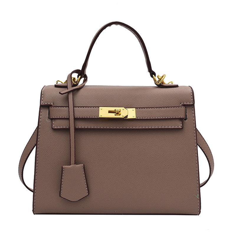 Brown handbag with gold hardware on a white background
