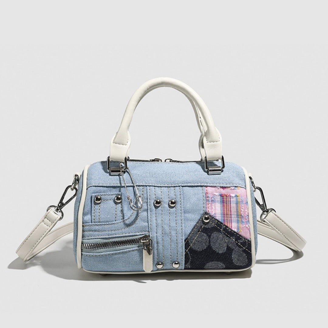 Denim handbag with patchwork design on a light gray background