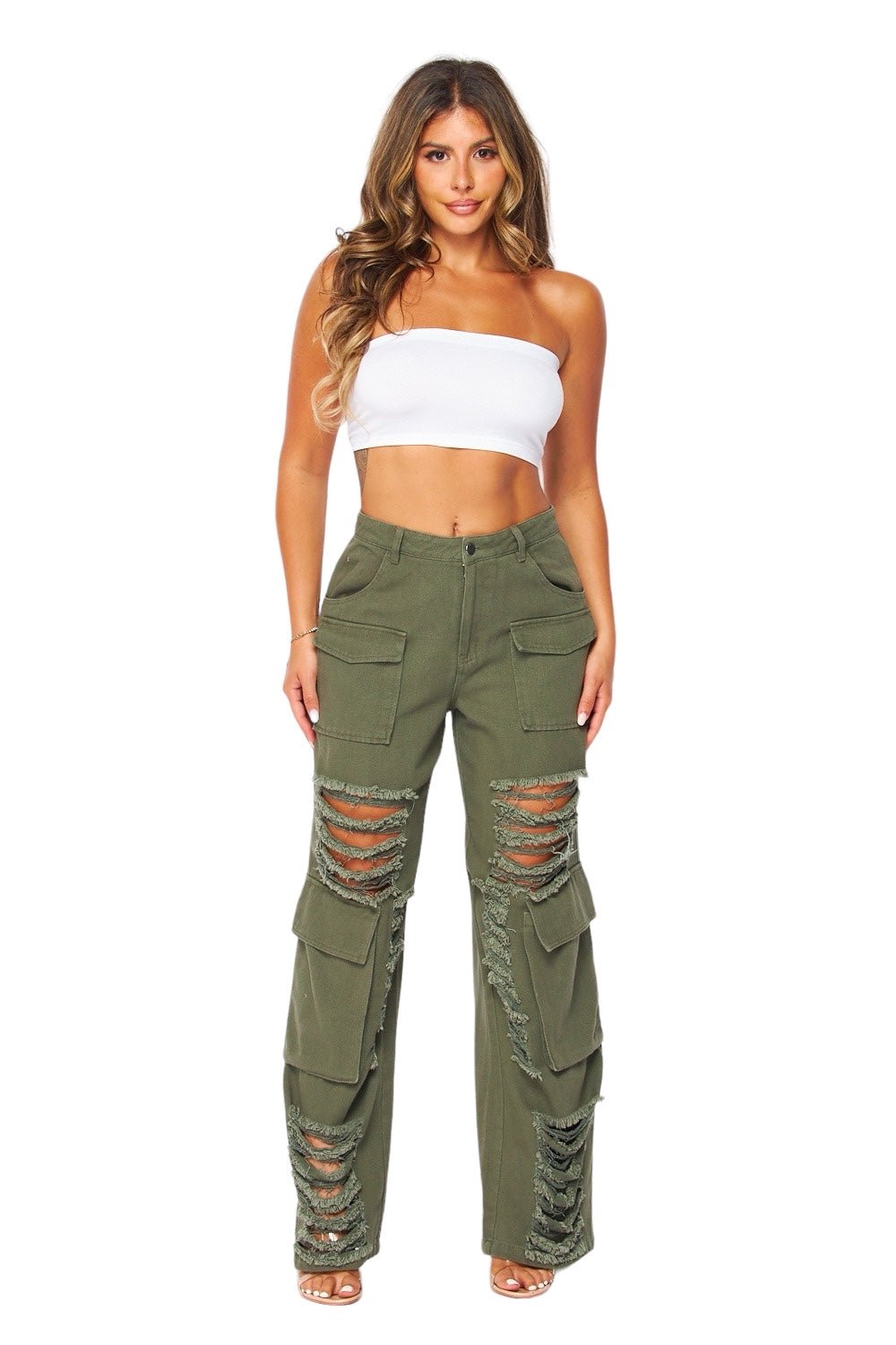 Woman wearing a white strapless top and green ripped cargo pants on a white background