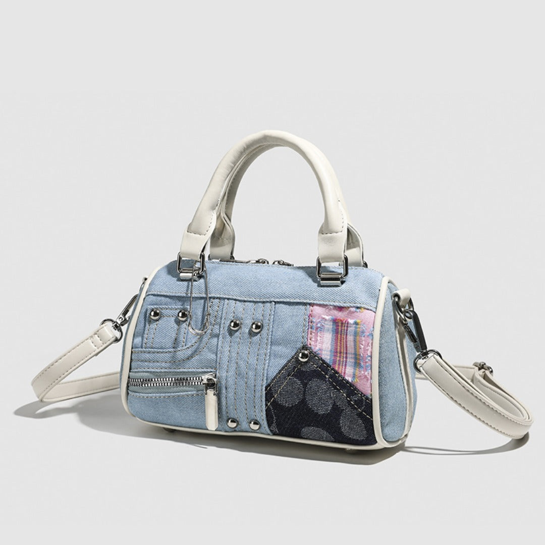 Denim handbag with plaid accents on a light gray background