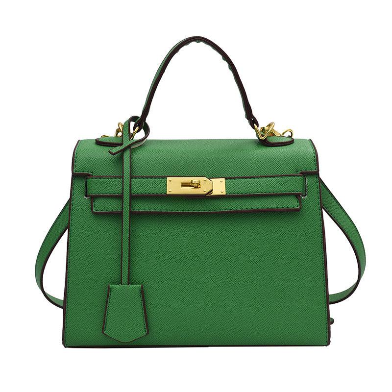 Green handbag with gold hardware on a white background