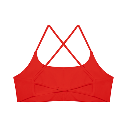 Red seamless U-neck sports bra for with crisscross straps for women on a white background