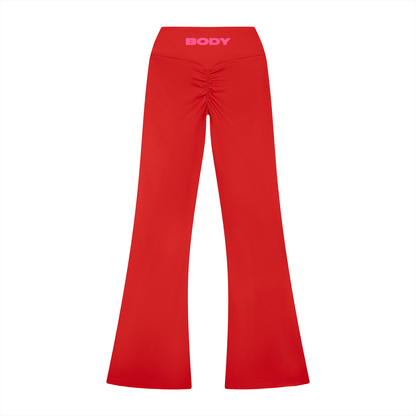 Red flare bottom leggings with 'BODY' branding on waist band on a white background