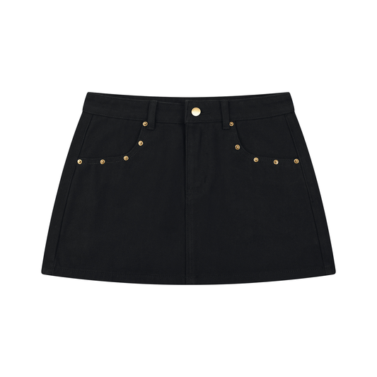 A black denim mini skirt with gold-tone metal studs and a button closure, displayed flat against a solid white background.