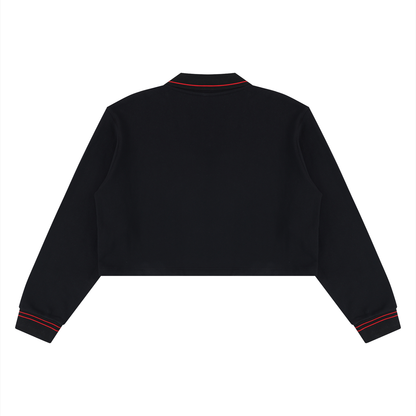 A black cropped long-sleeve sweatshirt shown from the back, featuring red contrast stitching details along the collar and cuffs, set against a plain white background.