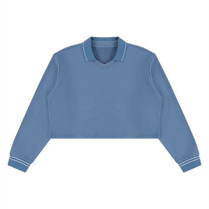 A dusty blue long-sleeve polo shirt with white contrast stitching on the collar and cuffs, displayed flat against a solid white background.