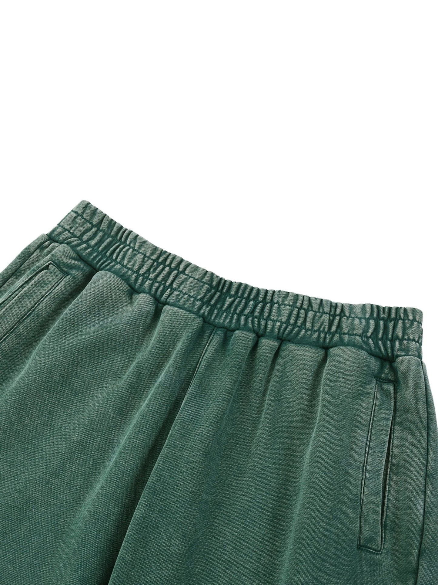 Close-up of Green sweatpants with an elastic waistband on a white background