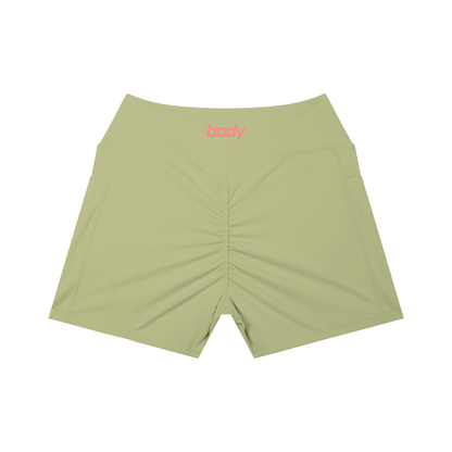 Light olive-green shorts with word 'body' on waist band shown against a white background
