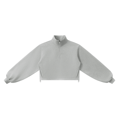 Light gray long-sleeve mock neck crop top sweatshirt with a quarter zip on a white background