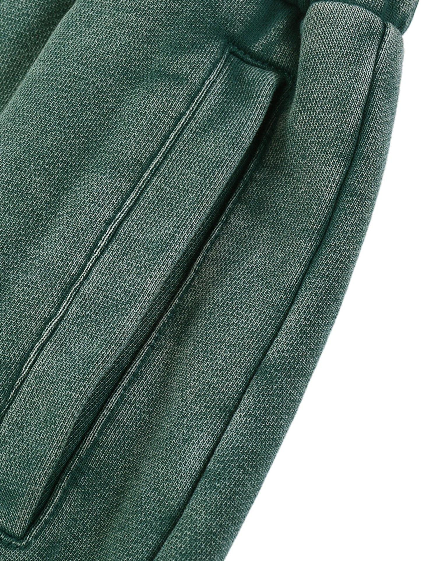 Close-up of green sweatpants fabric with a white background